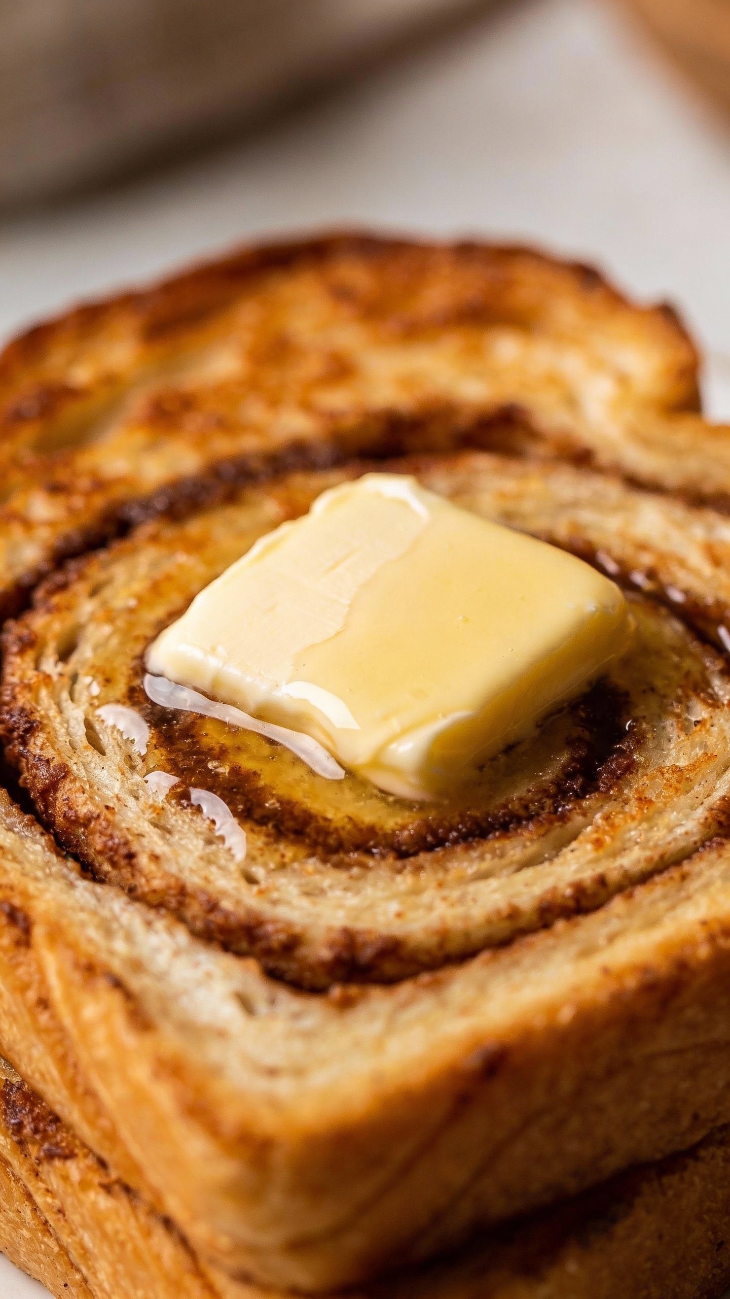 toasted keto cinnamon swirl bread with melting butter pat