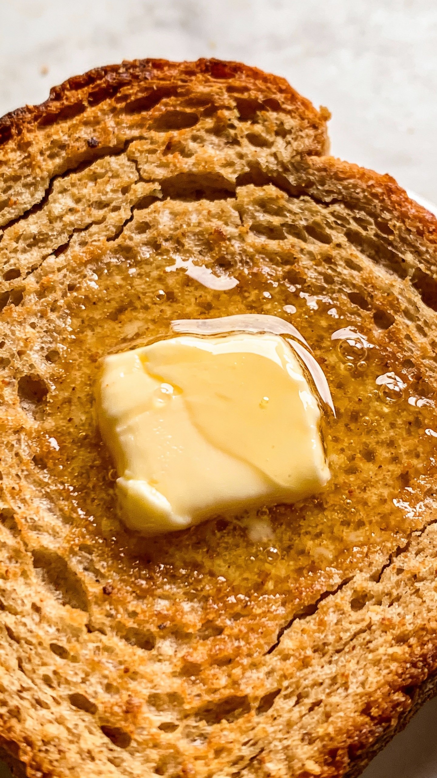 toasted keto almond flour bread slice with butter melting