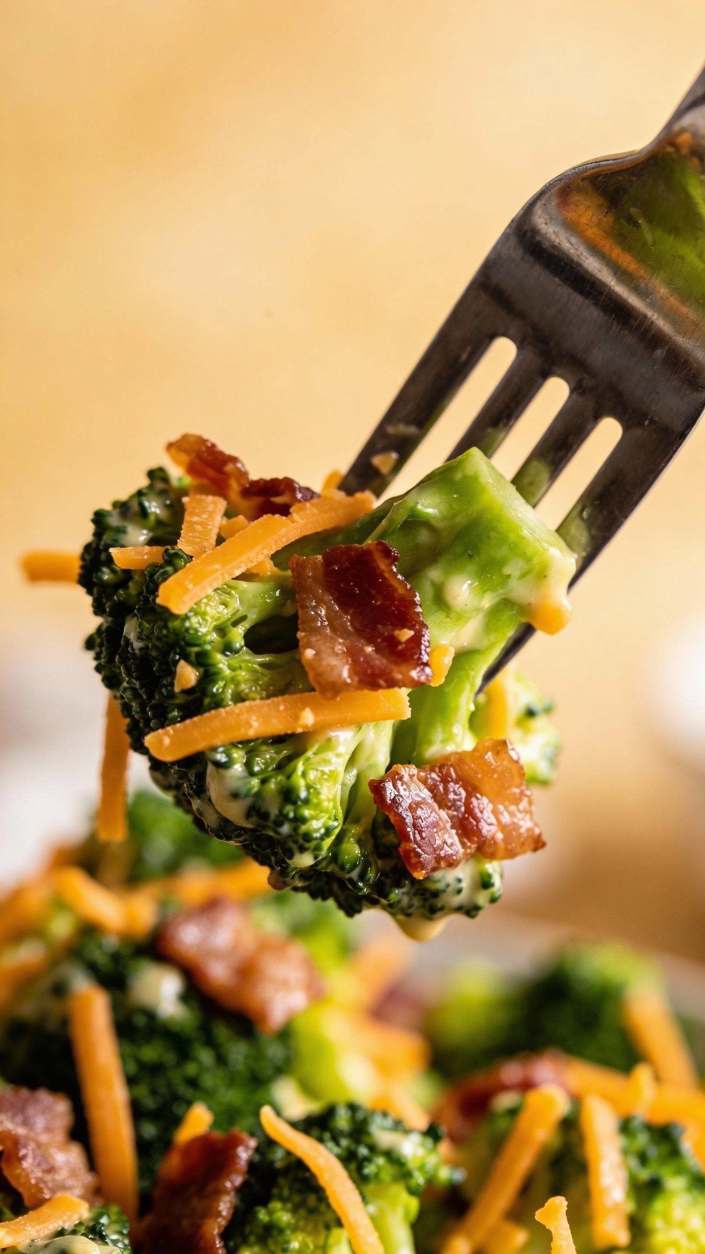 single forkful of broccoli salad with bacon and cheddar