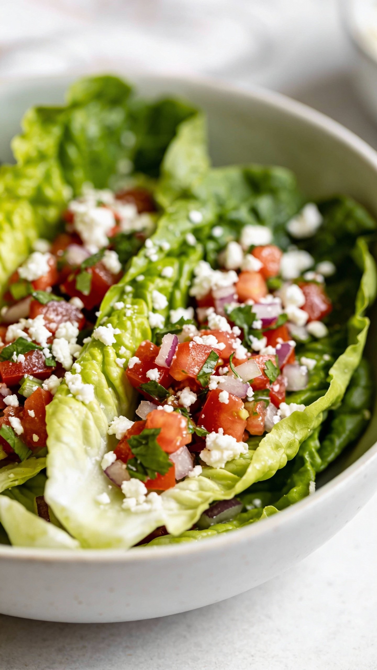 closeup romaine lettuce tossed with pico and cotija, bowl