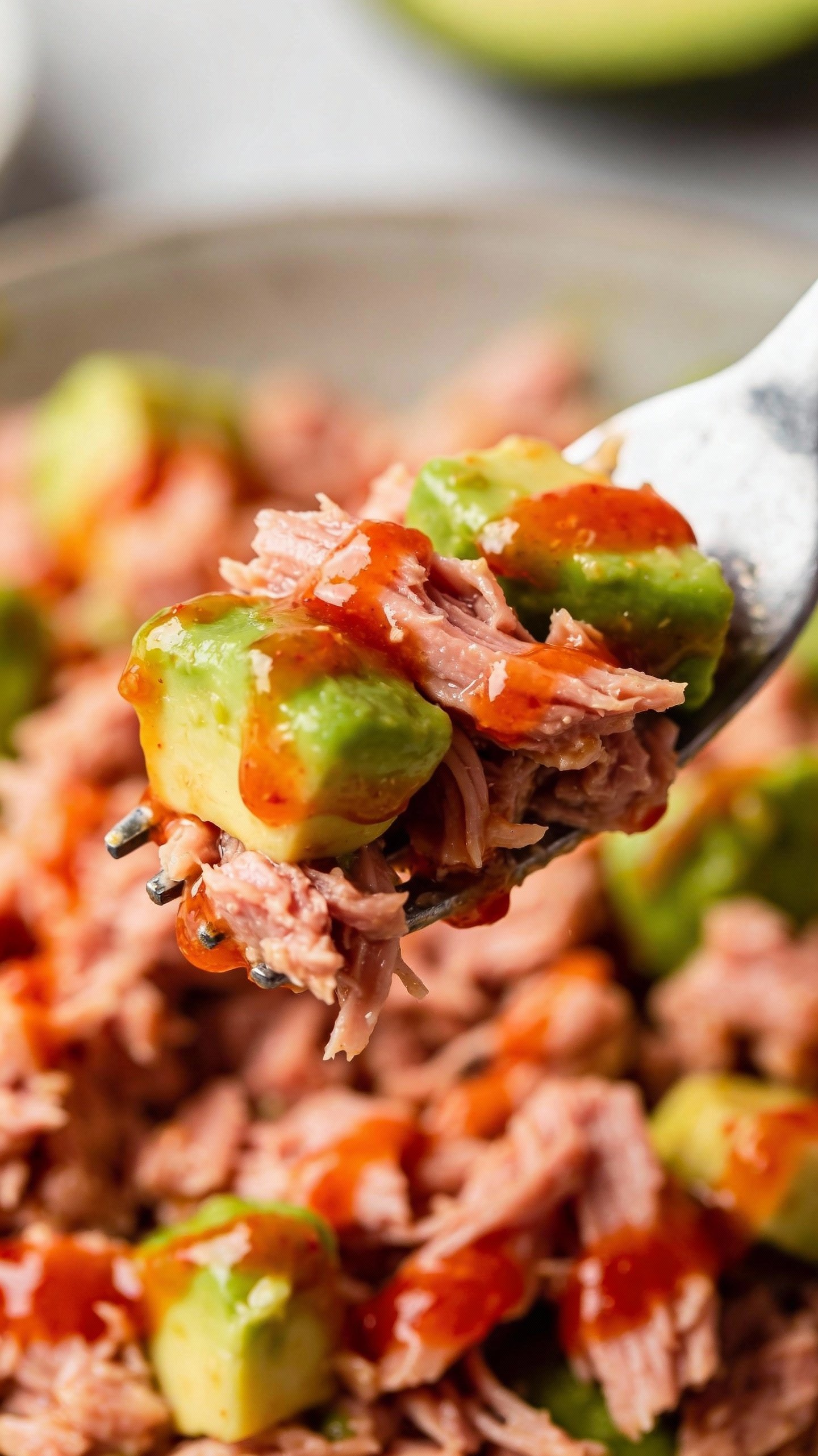 forkful of avocado-studded sriracha tuna salad, macro shot