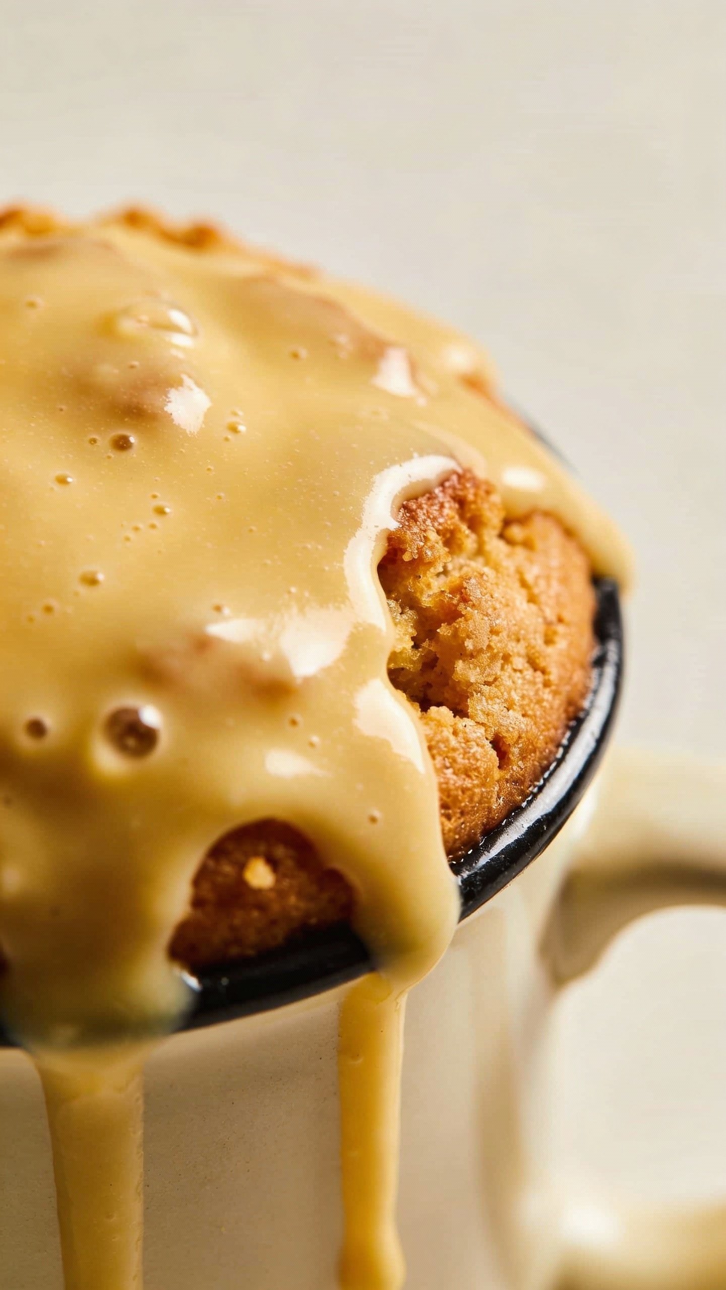 buttery keto cream cheese glaze dripping on mug cake top