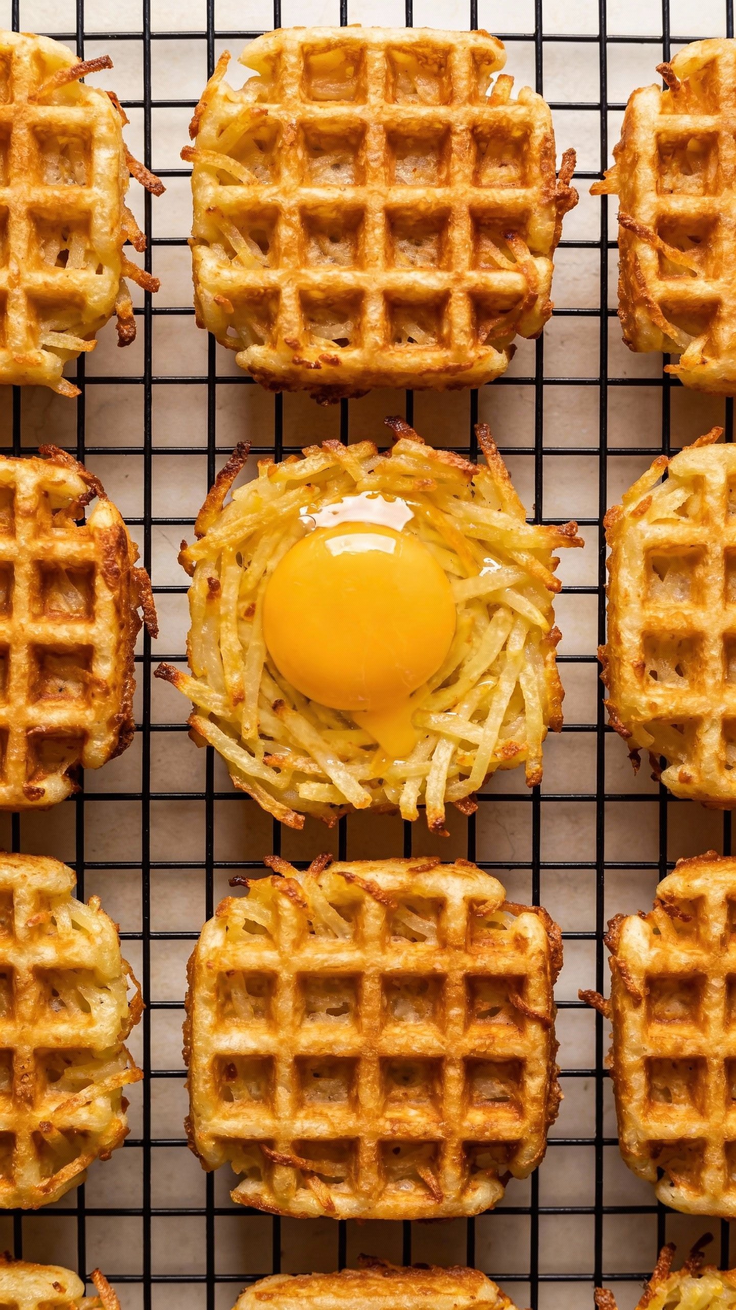 golden keto waffle hash brown with runny egg yolk in grid