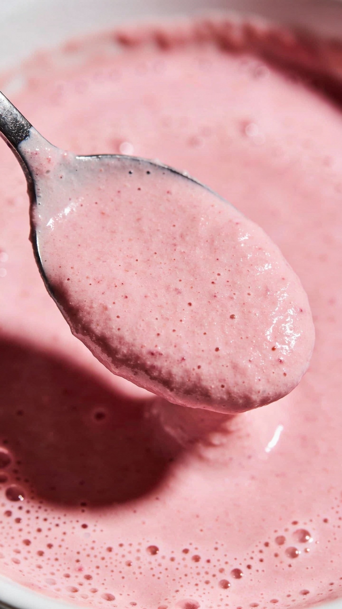 spoonful of thick pink keto smoothie, macro shot