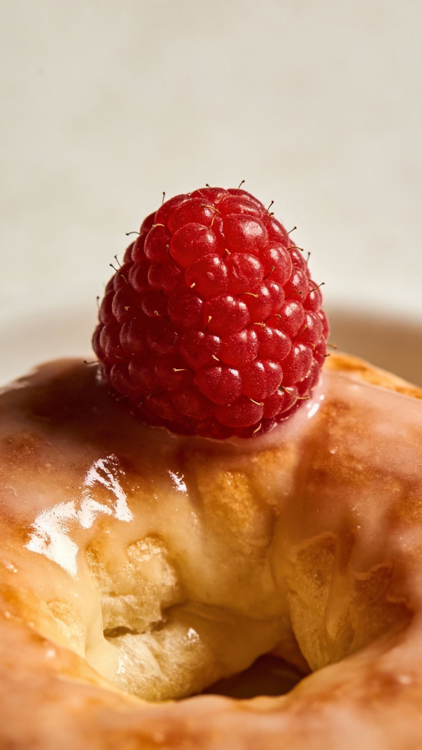 tart fresh raspberry atop glossy keto Danish glaze