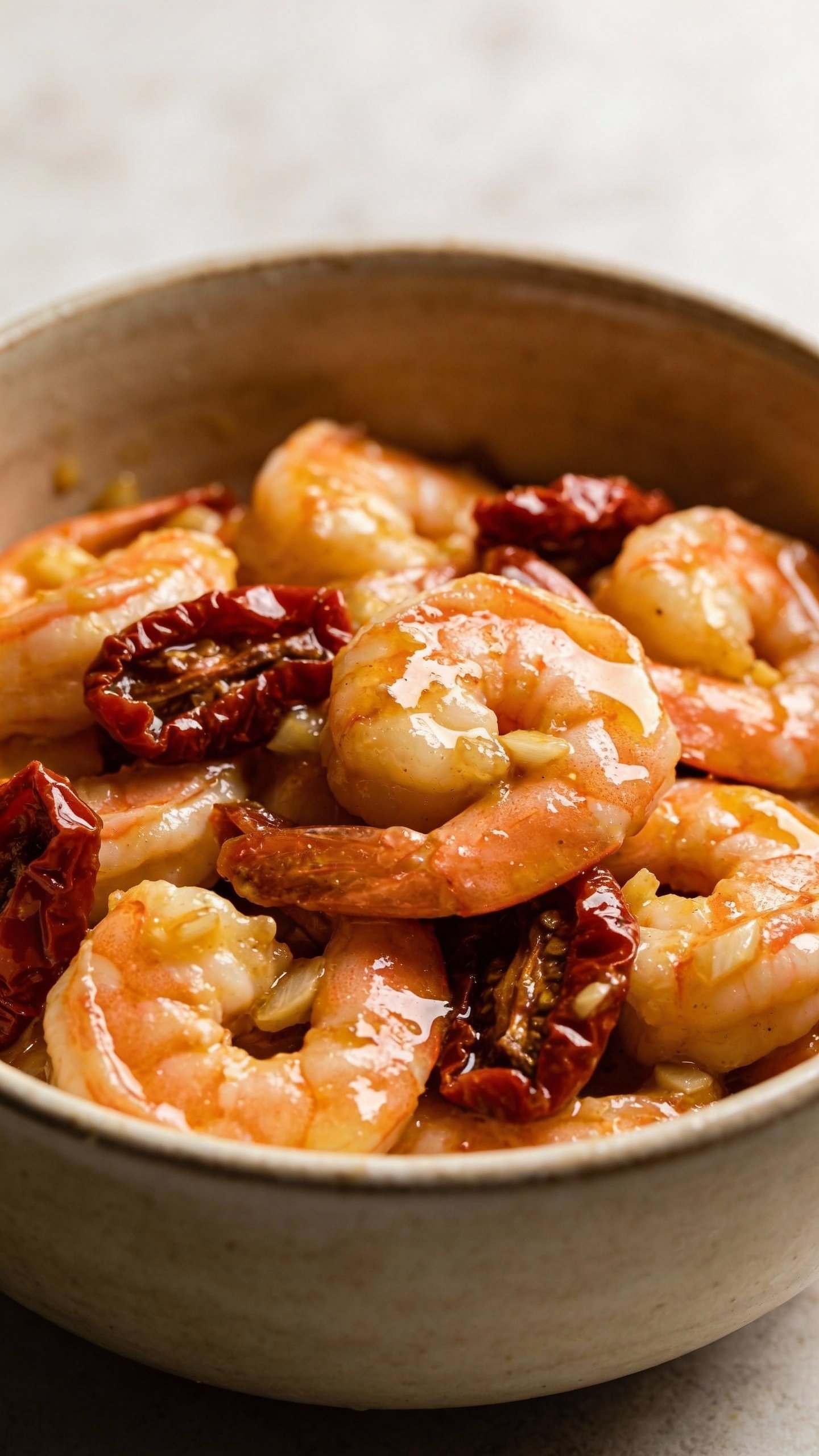 closeup bowl of Tuscan garlic butter shrimp with sun-dried tomatoes