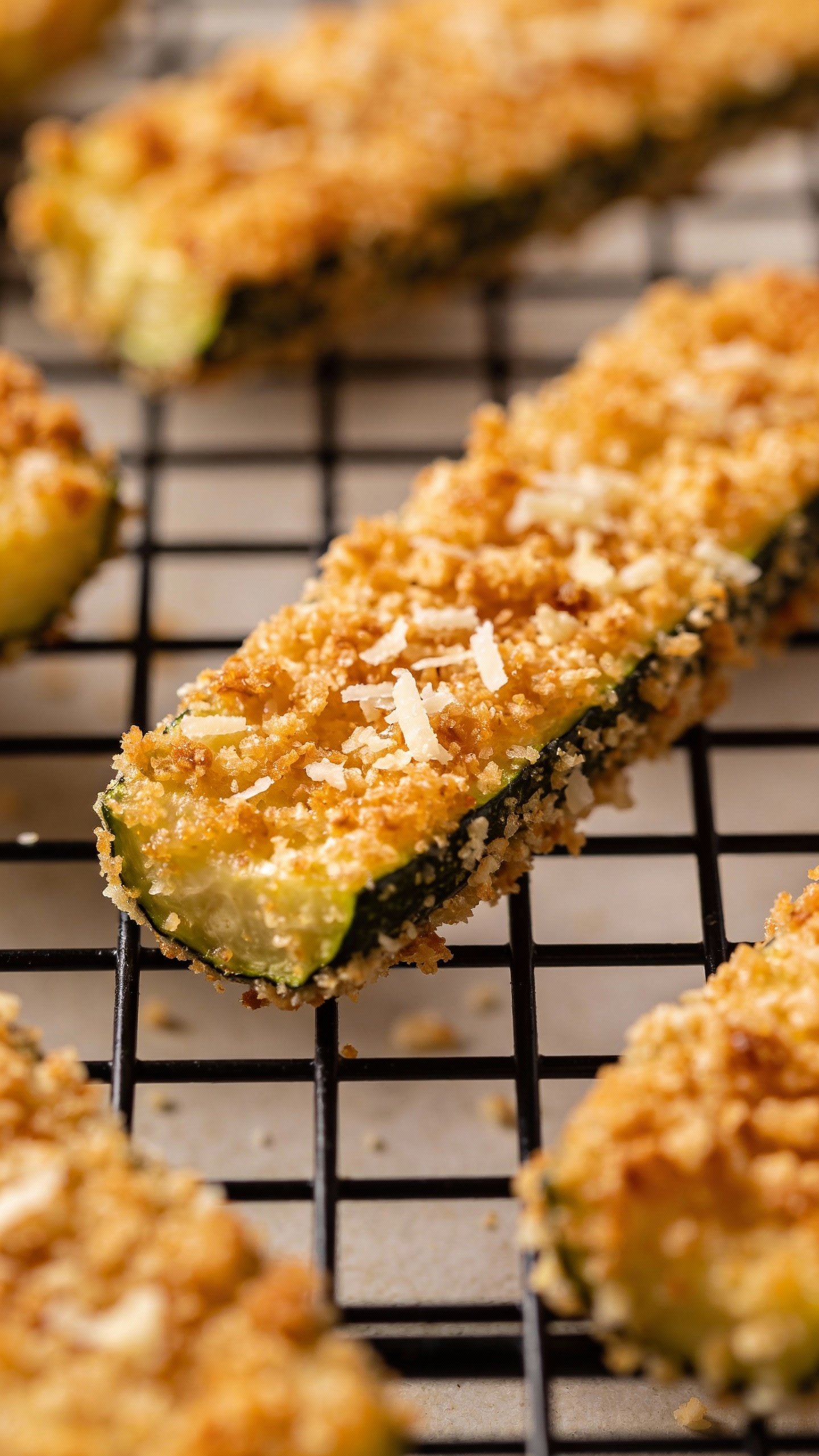 closeup of parmesan crusted zucchini fry on wire rack