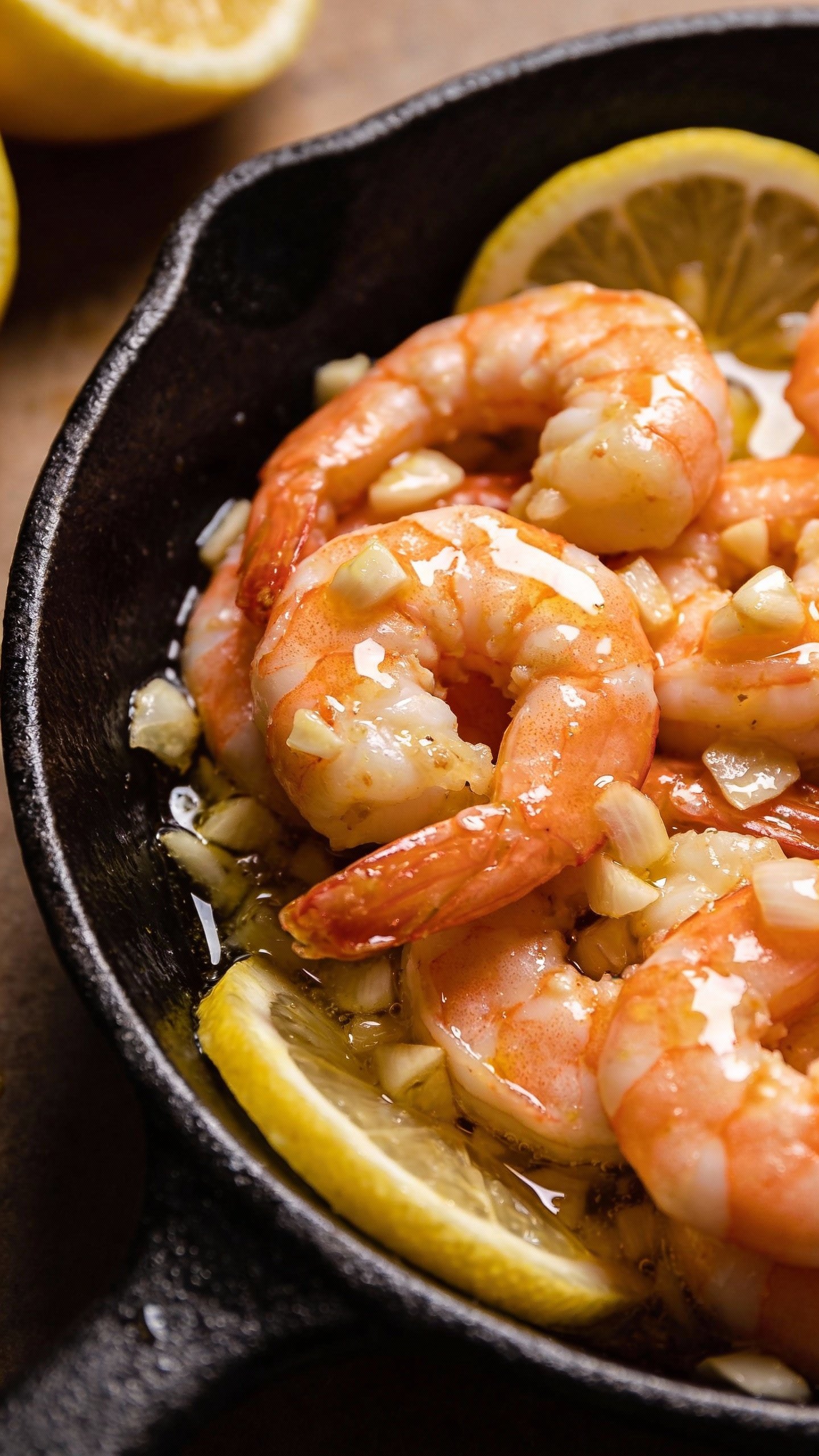 single skillet of garlic butter shrimp, glossy lemon finish