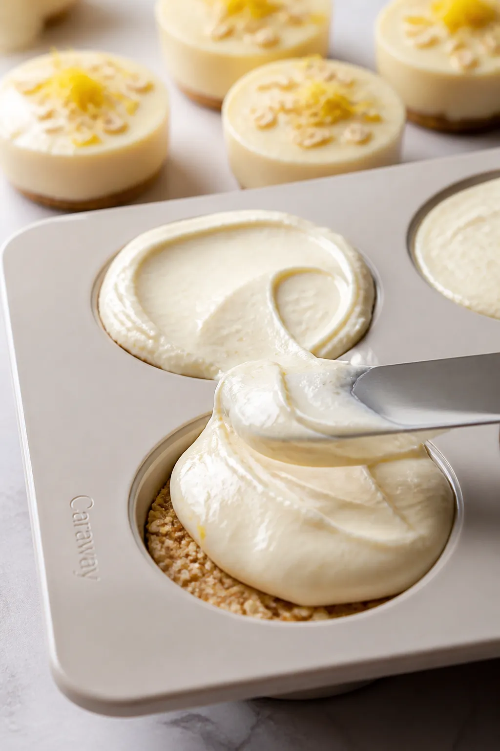 Close-up process scene of the lemon cheesecake filling being smoothed over the set crust in a silico