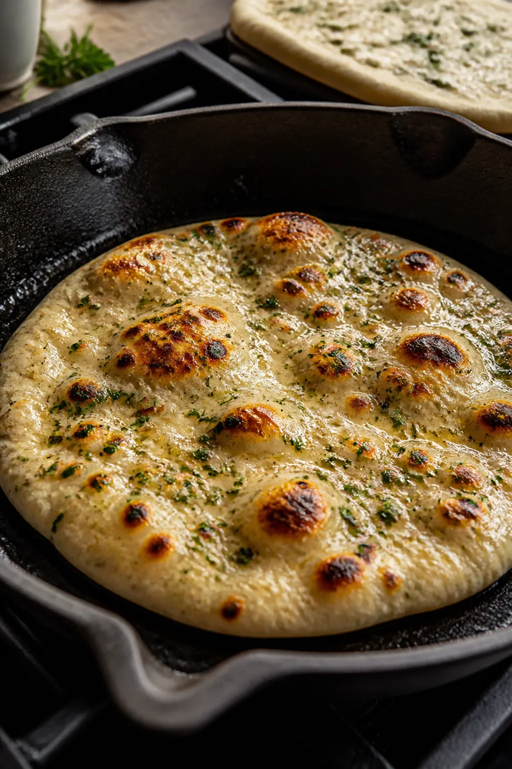 Cooking process close-up: Cottage Cheese Garlic Herb Flatbread puffing and blistering in a preheated