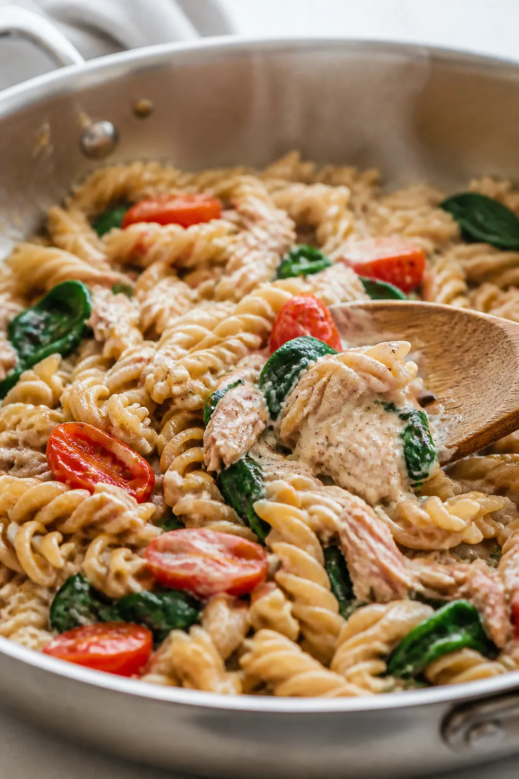 Cooking process, close-up detail: In a wide stainless skillet over medium heat, glossy whole-wheat f