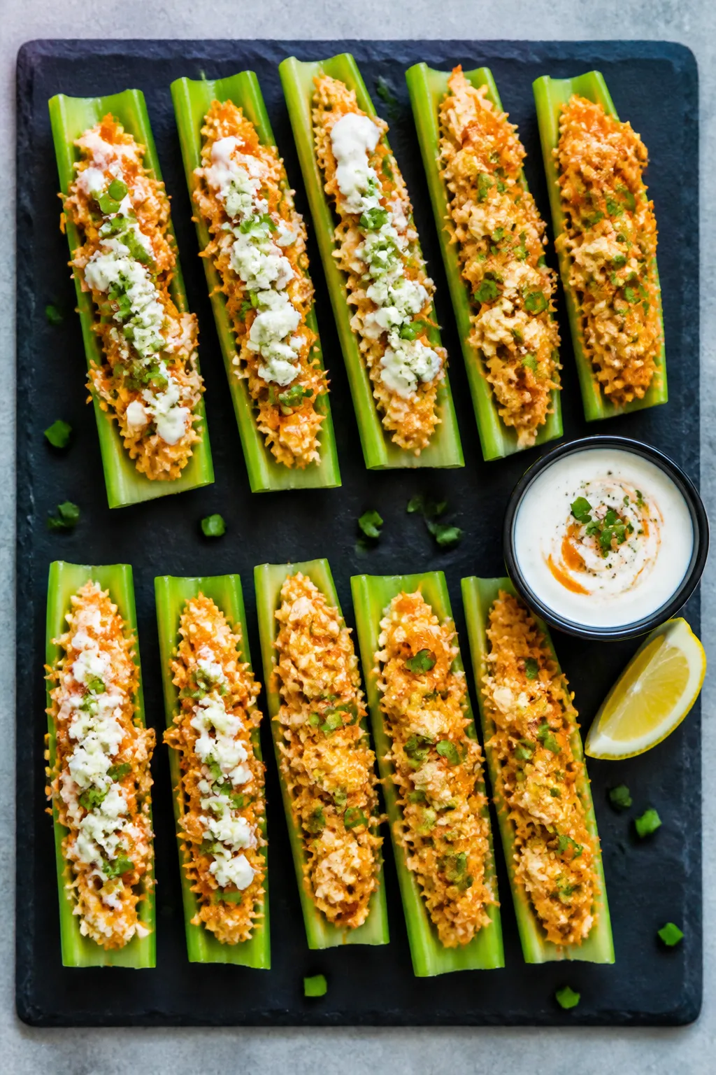 Overhead final presentation: A platter of High Protein Buffalo Chicken Celery Boats arranged in neat