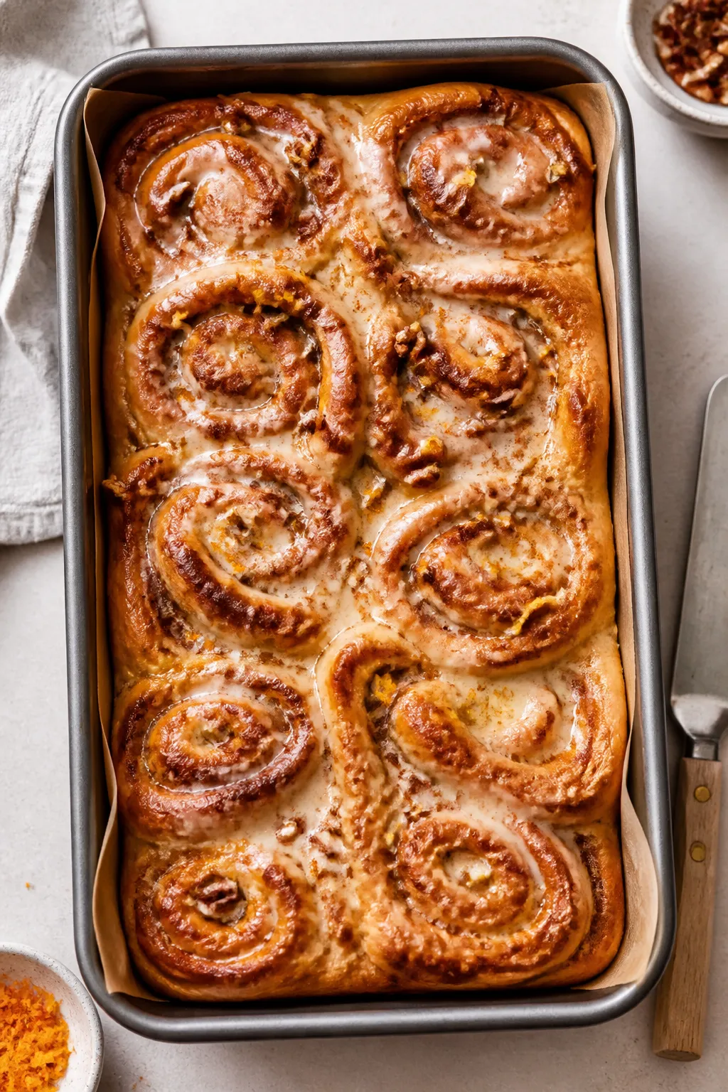 Overhead shot of a freshly baked Cottage Cheese Cinnamon Roll Bake in a 9x13 pan, golden puffed top 